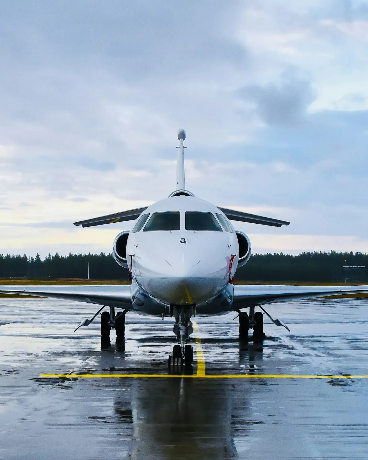 Business jet facing the camera on a wet runway